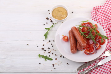 sausages on plate with vegetables