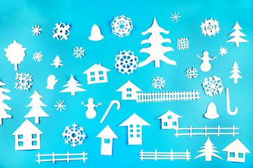 Fototapeta na wymiar Christmas theme figures made of white paper on blue background
