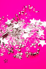 Silver sparkles on pink background. Holiday concept.