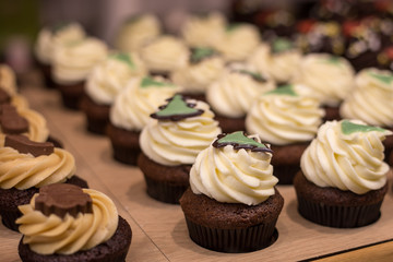 Shop window with vanilla cupcakes, bakery store. Food concept