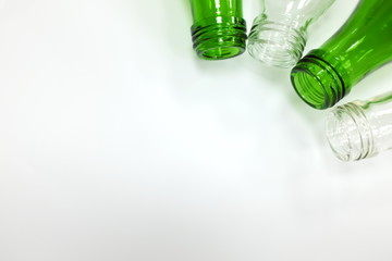 Fototapeta premium Recycled glass bottles in white background showing plastic free concept