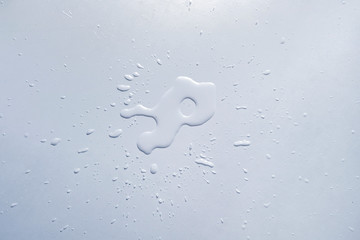 water splash lit on the white table surface, abstract raindrops