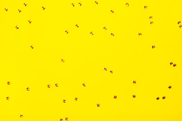 Golden sparkles on yellow background. Holiday concept.