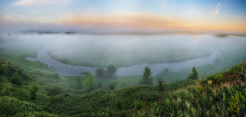 fog in the river valley. picturesque spring morning. beautiful foggy sunrise in a foggy meadow