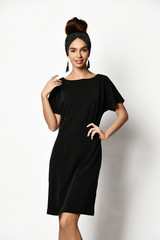 Young beautiful woman posing in new fashion long casual dark black winter dress happy smiling walking full body