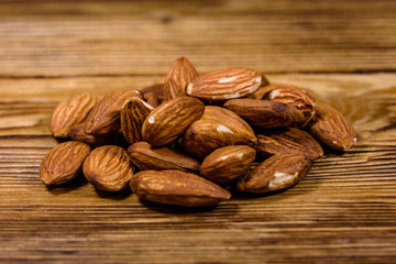 Heap of the peeled almond nuts on wooden table