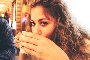A beautiful girl drinks hot tea during the winter season!