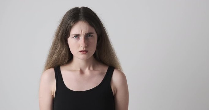 Shocked young woman suspiciously looking at far end