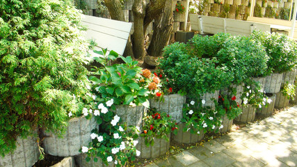 Stone decoration with different green plants and blooming flowers in restaurant Vila Nesic or Blue fish near Drina river and Sepak border                  
