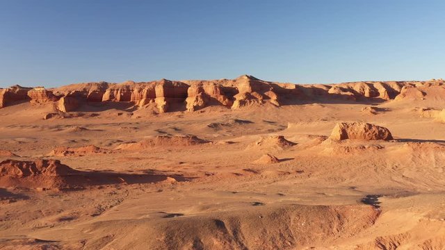 Martian landscape. Flaming Cliffs aerial view in the Gobi Desert, South Mongolia. Bayanzag region is most famous for yielding the first discovery of dinosaur eggs. Mongolia. Canyon Hermen-Tsav.