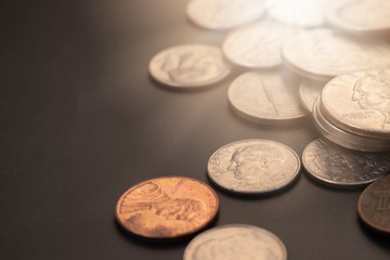 Money, US Dollars bank notes, penny, nickel, dime, quarter on black background. Finance and economy concept.