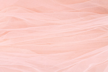 The delicate background with peach color tulle. Wedding.