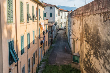 Narrow streets of Lucca ancient town with traditional architecture, Italy