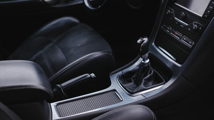 Fototapeta na wymiar Black interior of a modern car, six-speed manual shift car gear lever.