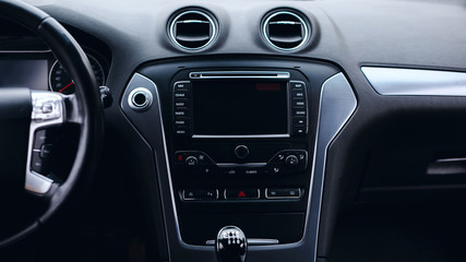 Obraz na płótnie Canvas luxury car Interior - multimedia display, steering wheel, shift lever and dashboard. 