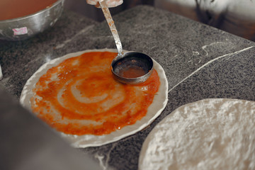 Chef prepare the pizzaa. Man in a white uniform