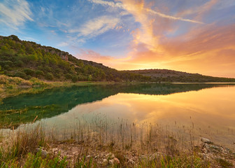 Landscape view of the sunset in the Laguna La Lengua Lake of the Lagunas de Ruidera Lakes Natural Park, Albacete province, Castilla la Mancha, Spain	