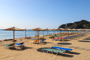 Fototapeta na wymiar The sea coast, beach chairs and umbrellas from the sun.