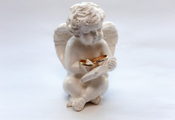  angel figurine hold two wedding rings