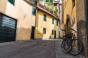 Narrow streets of Lucca ancient town with traditional architecture, Italy