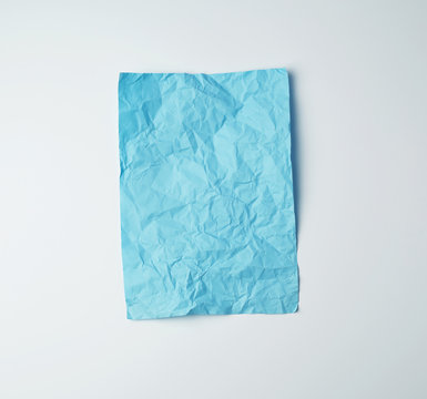 empty crumpled blue rectangular sheet of paper on a white background
