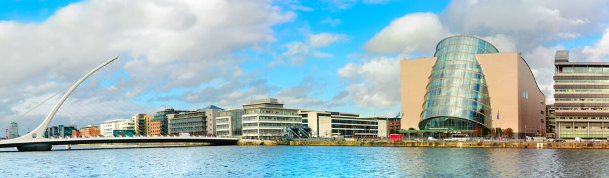 Trendy Dublin riverside. Panoramic image of Convention Centre and Samuel Beckett Bridge over the river Liffey in refurbished docklands area