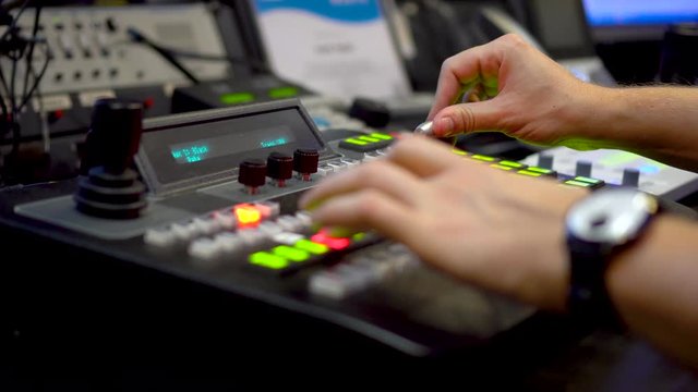 Live tv broadcast from video mixer console with mens hands