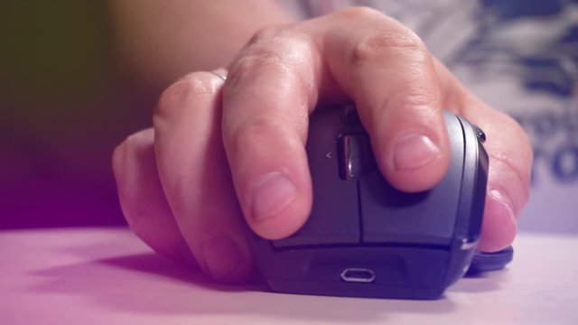 Hand of man clicking and surfing in internet using computer mouse