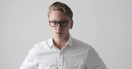 Angry businessman gesturing a threat to cut throat with his finger as knife