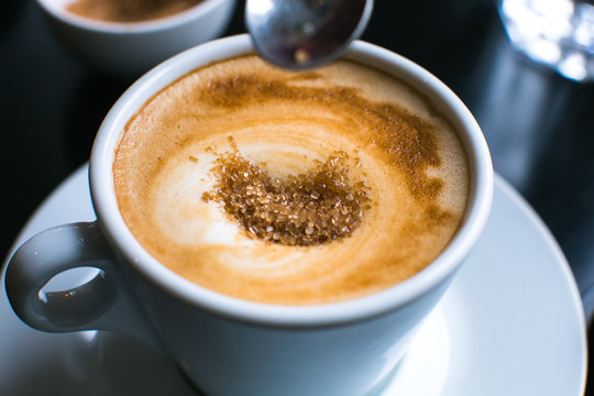 Pouring Brown Sugar In Coffee