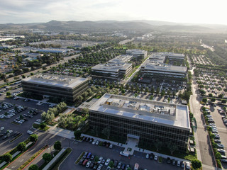 Aerial view of business and finance district with new office building surrounded by parking and road. Irvine Business Complex. Irvine California. USA - obrazy, fototapety, plakaty