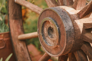 Close up center of rustic wagon wheel with cobwebs made of metal and wood