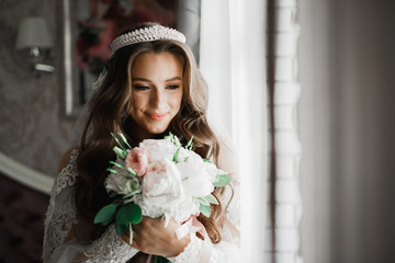 Portrait of stunning bride with long hair posing with great bouquet