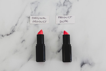 beauty industry competition, two identhical looking lipsticks with Original Product and Product Dupe labels