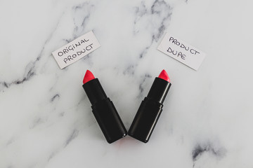 beauty industry competition, two identhical looking lipsticks with Original Product and Product Dupe labels