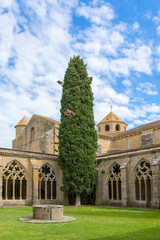 Fototapeta na wymiar The patio with a well and a grassplot in the Cistercian monastery of Santa Maria la Real de la Oliva