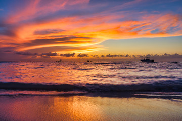 Landscape of tropical island beach, sunset. Beautiful sunset over the sea  on the white beach on a Caribbean Mujeres island Mexico