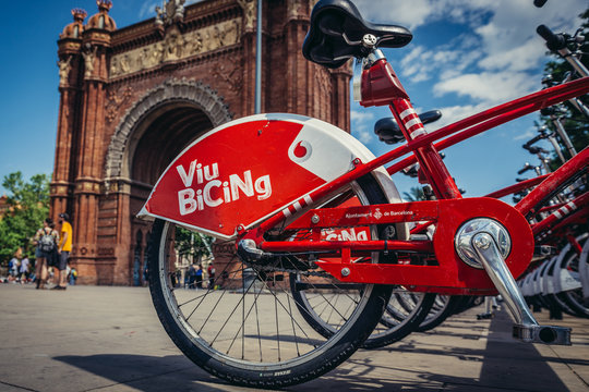 Barcelona, Spain - May 23, 2015. Viu Bicing share system next to triumphal arch at Lluis Companys Promenade in Barcelona