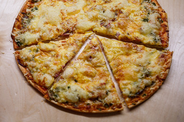 Home cooked pizza on a wooden board