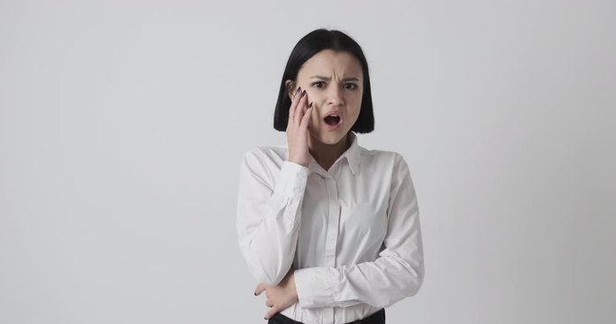 Serious young woman disgusted over white background