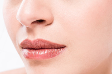 Perfect natural lip makeup. Close up macro photo with beautiful female mouth.