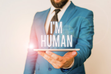 Conceptual hand writing showing I M Huanalysis. Concept meaning used for saying someone has been weak in the ways and got mistake Businessman in blue suite with a tie holds lap top in hands