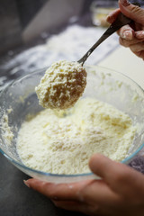 Baking domestic rolls with cheese. Putting cheese on dough for rolls