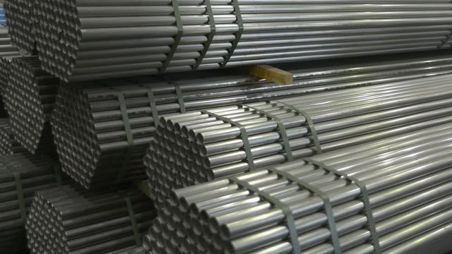 Stainless steel pipes in a warehouse of plant on production of metal pipes of a profile