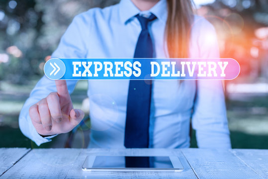 Word writing text Express Delivery. Business photo showcasing expediting the distributiuon of goods and services Female business person sitting by table and holding mobile phone