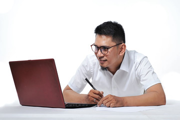 Young Asian business man/entrepreneur or freelancer laying on the floor.