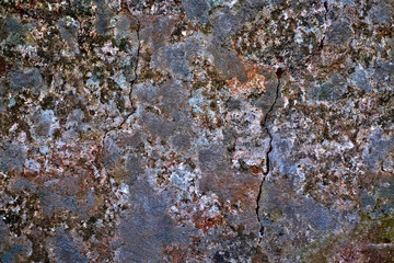 A dark cracked rock surface, natural mineral backgrounds and backdrops material - ecology and environment.