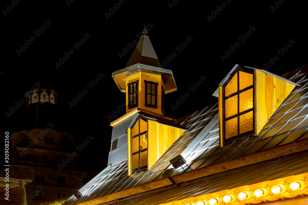 Wall mural christmas market stall with illuminated windows in aschaffenburg