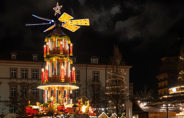 Christmas pyramid on the advent market at the Castle Johannisburg in city of Aschaffenburg in the...