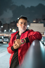 young man out in the street at night 